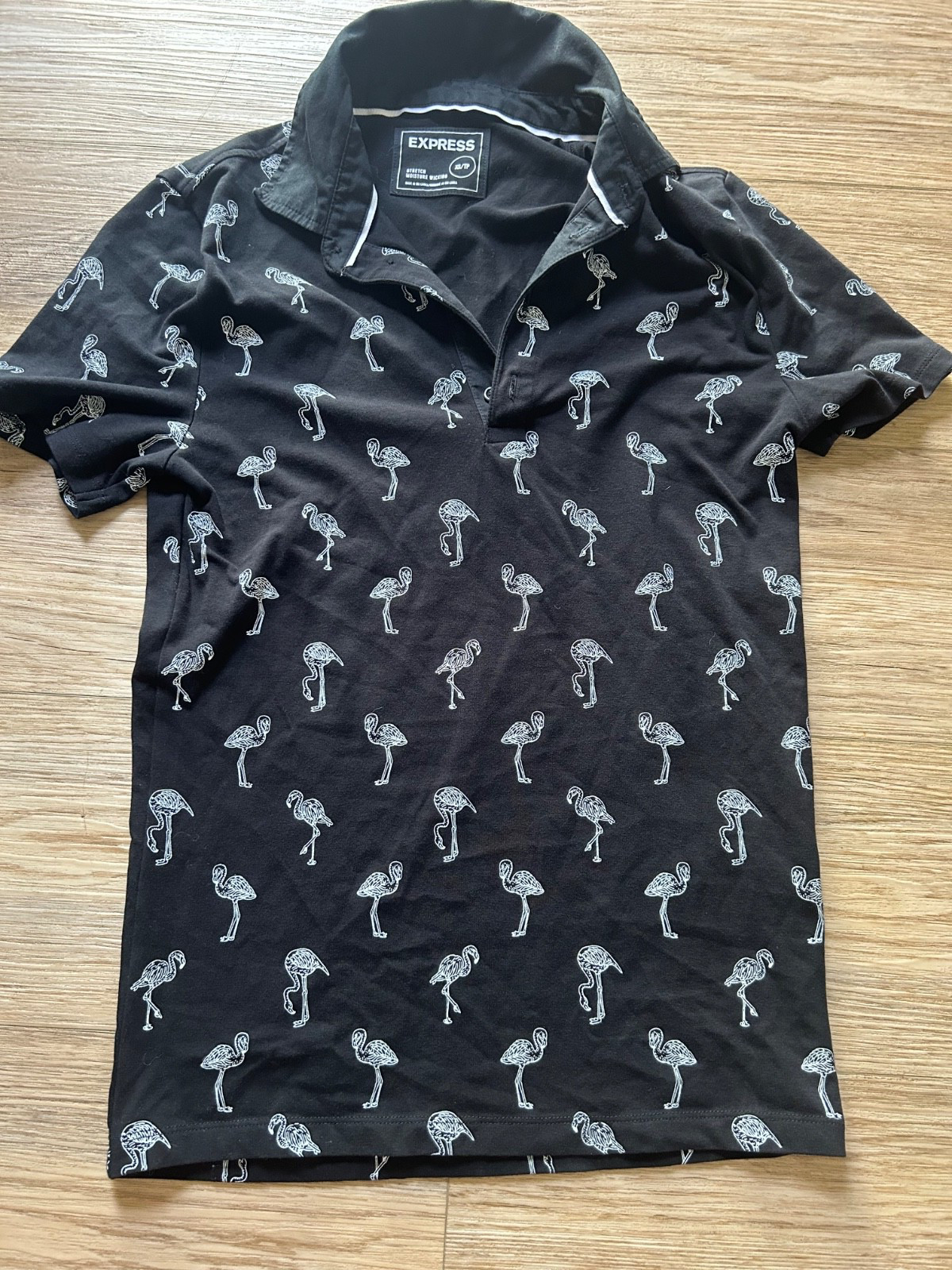 Women’s size XS black and white polo with all over flamingo print high stretch