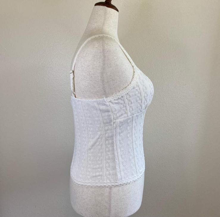 Soft and stretchy cami top with contoured chest and lace trim. Ivory. XL