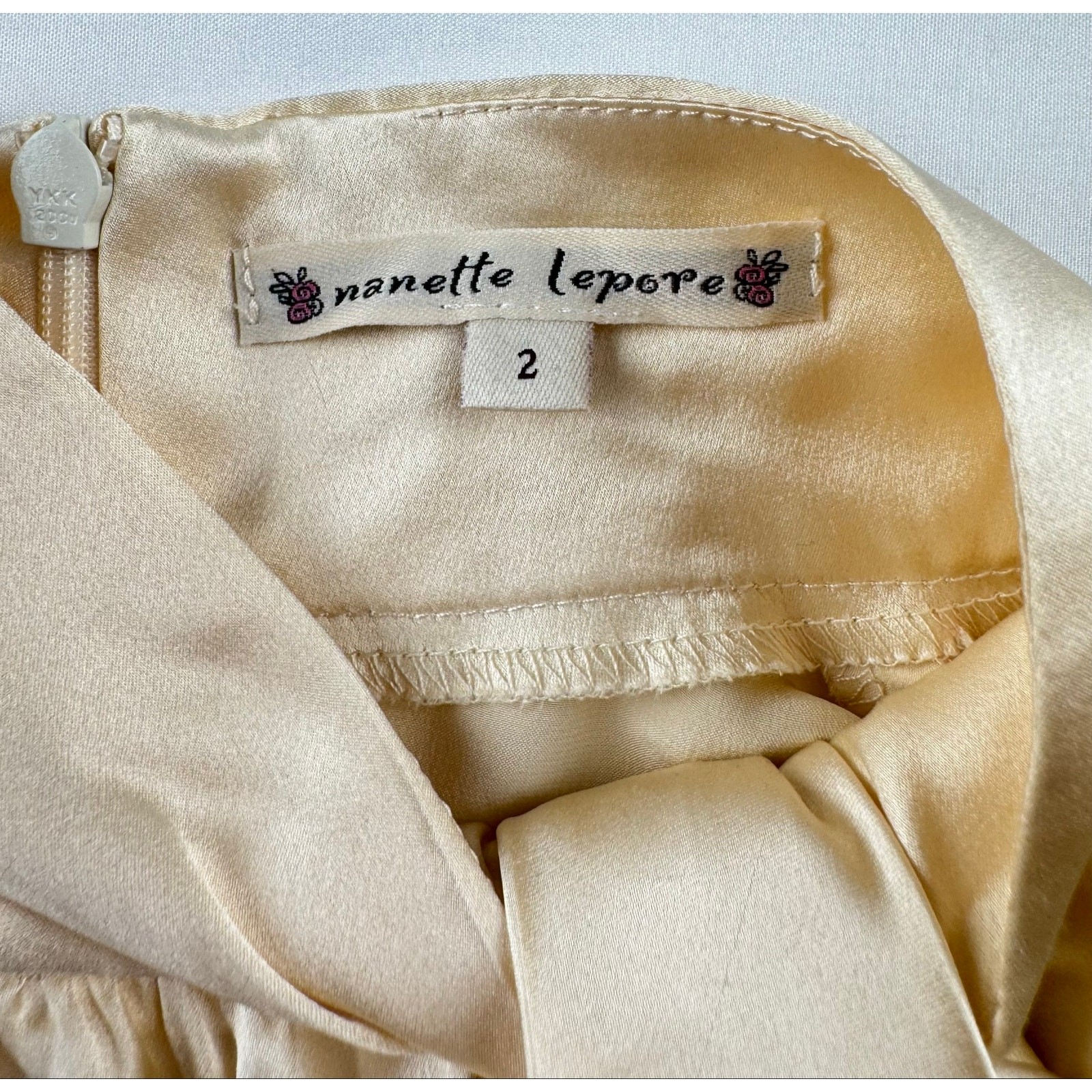 Nanette Lepore 100% Silk Sleeveless Bow Neck Blouse Champagne Ivory Size 2 USA
