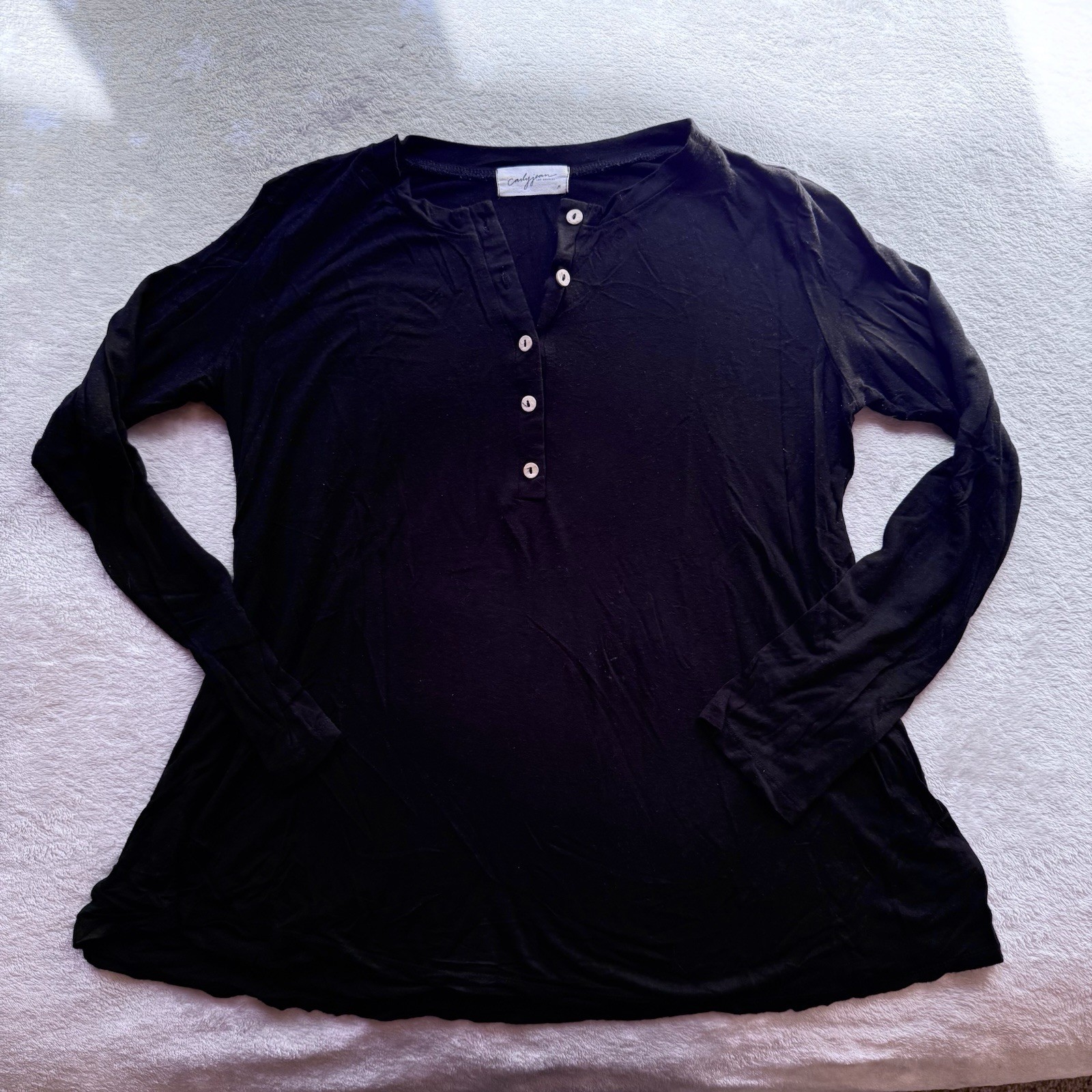 Black long sleeve top with button details from Carly Jean/size M