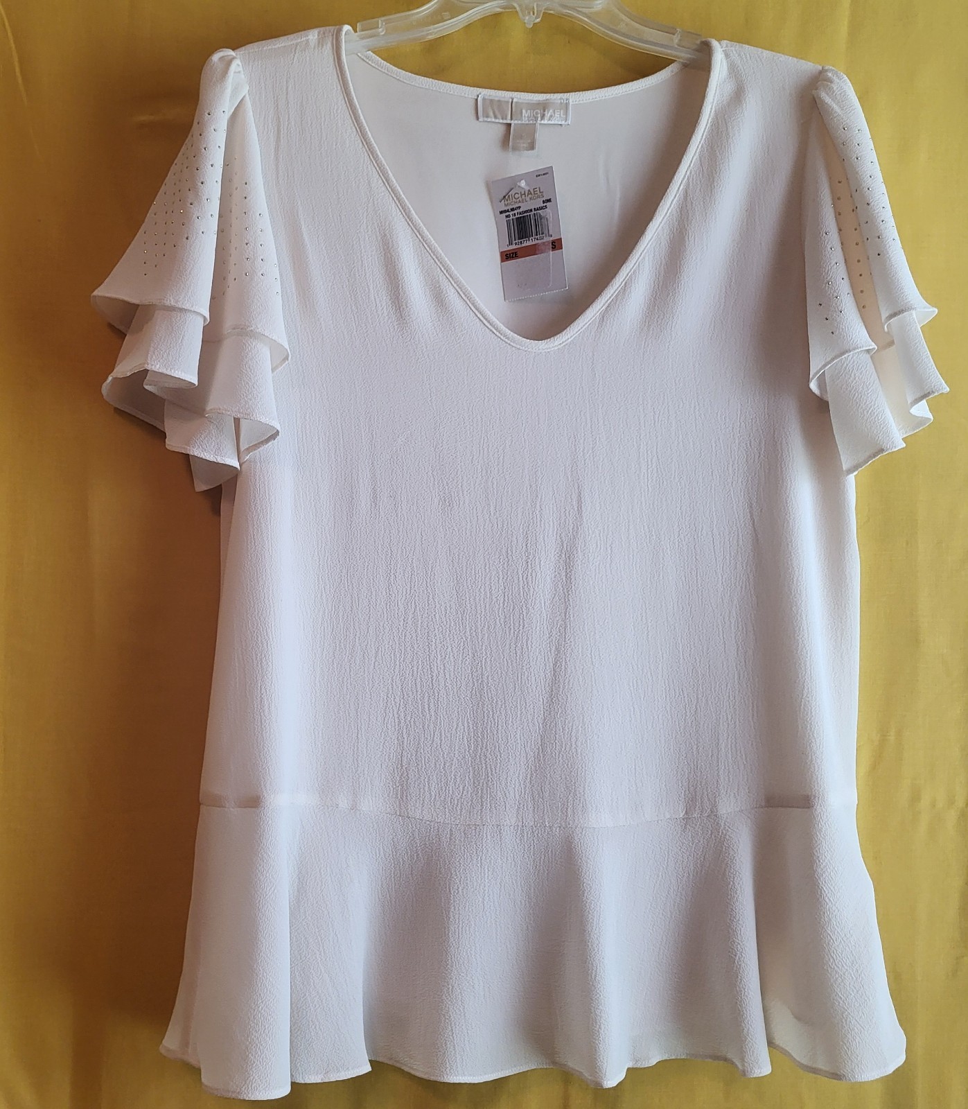 Embellished short fluted sleeved beige blouse to be worn as casual or dressy.