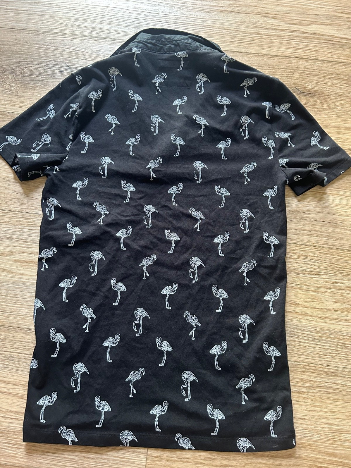 Women’s size XS black and white polo with all over flamingo print high stretch
