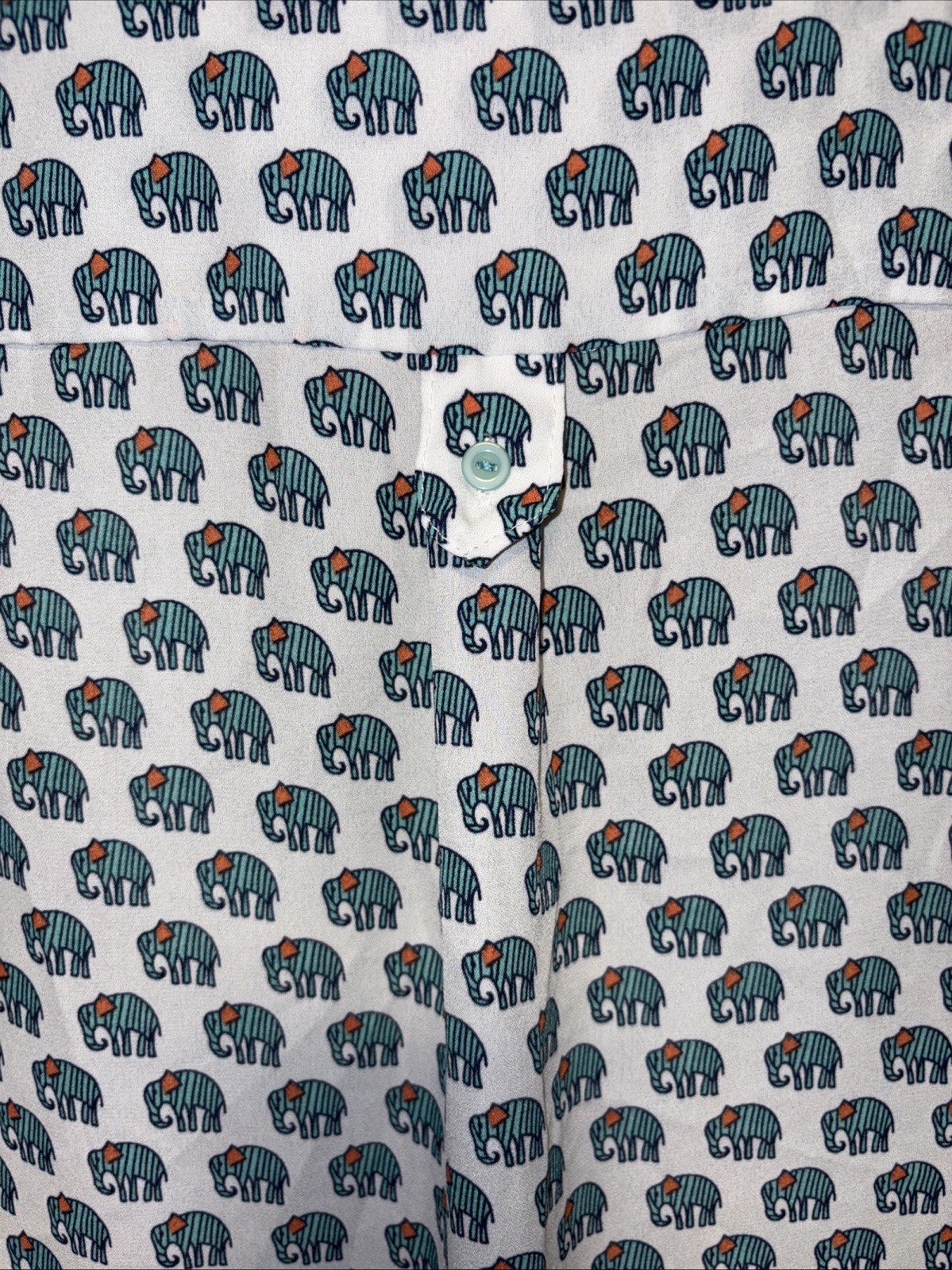 Cals blouse featuring an allover green elephant print on a rich White size Large