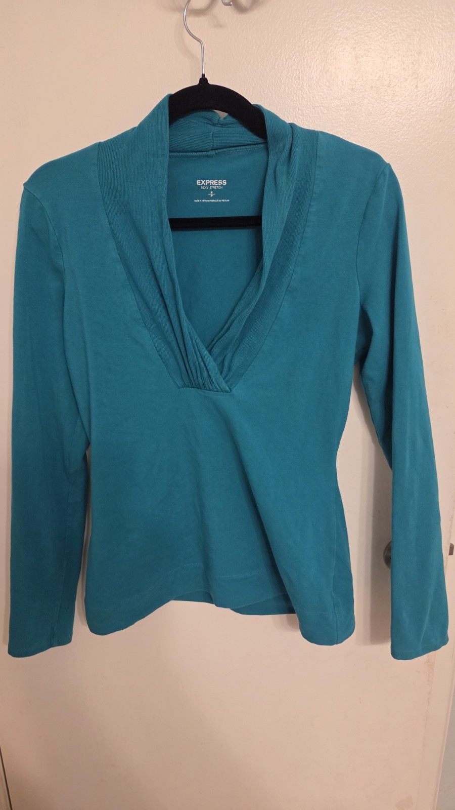 Express V-neck top featuring a distinct ruched neckline detail. Size S