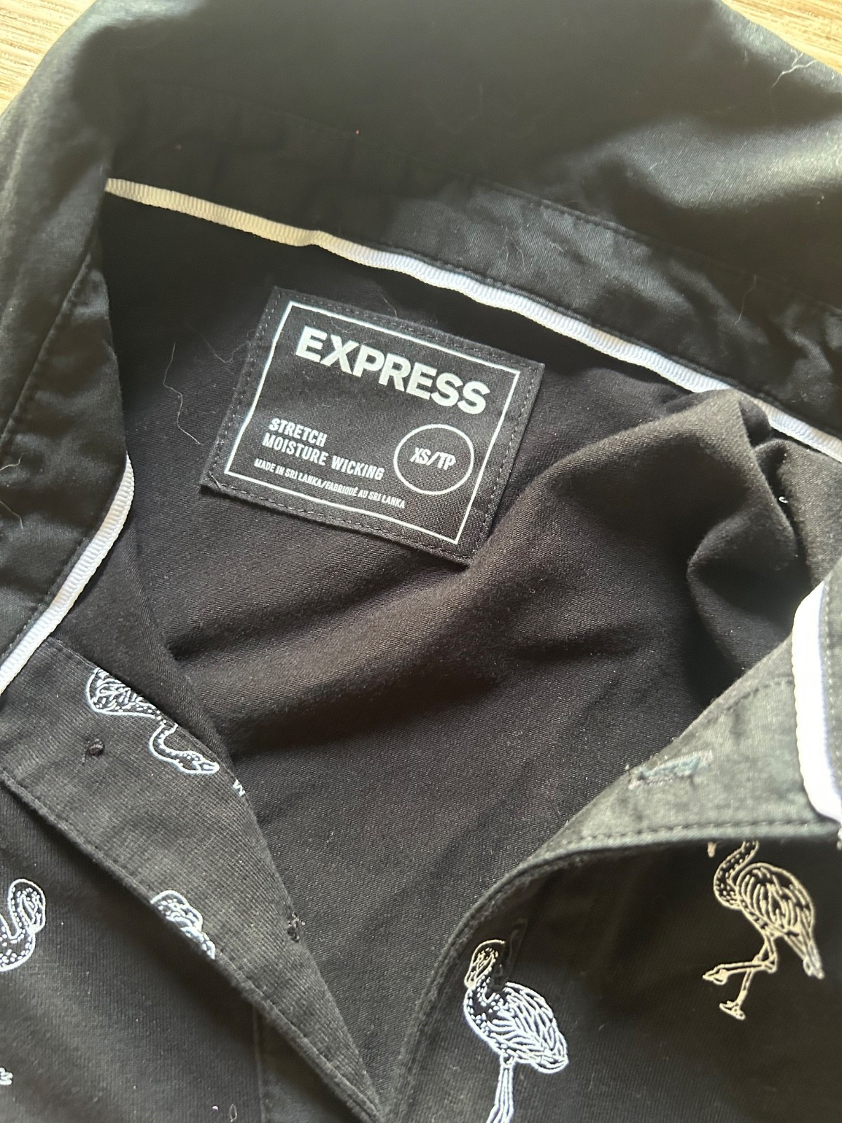 Women’s size XS black and white polo with all over flamingo print high stretch