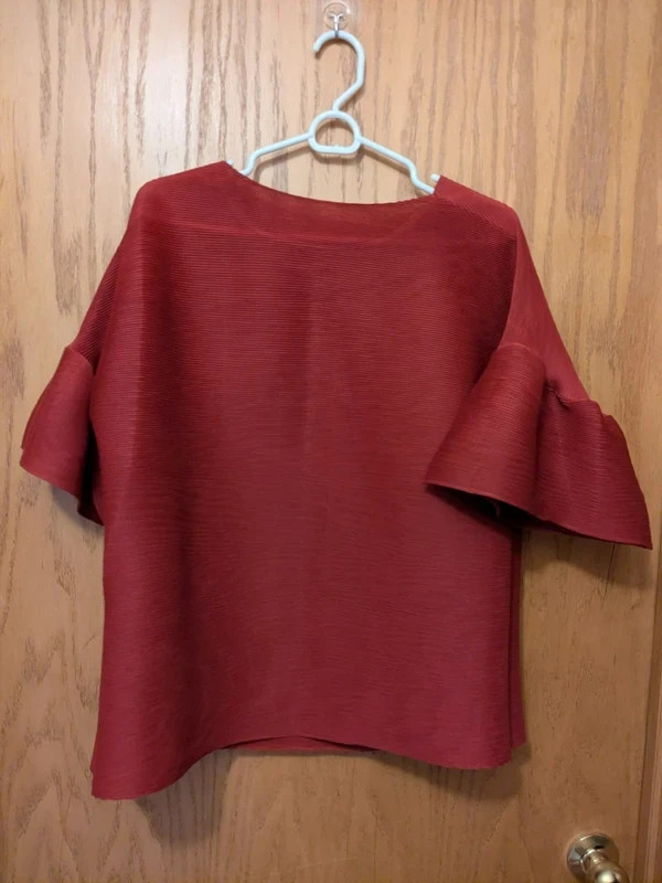 Featuring dynamic, tiered ruffle sleeves top