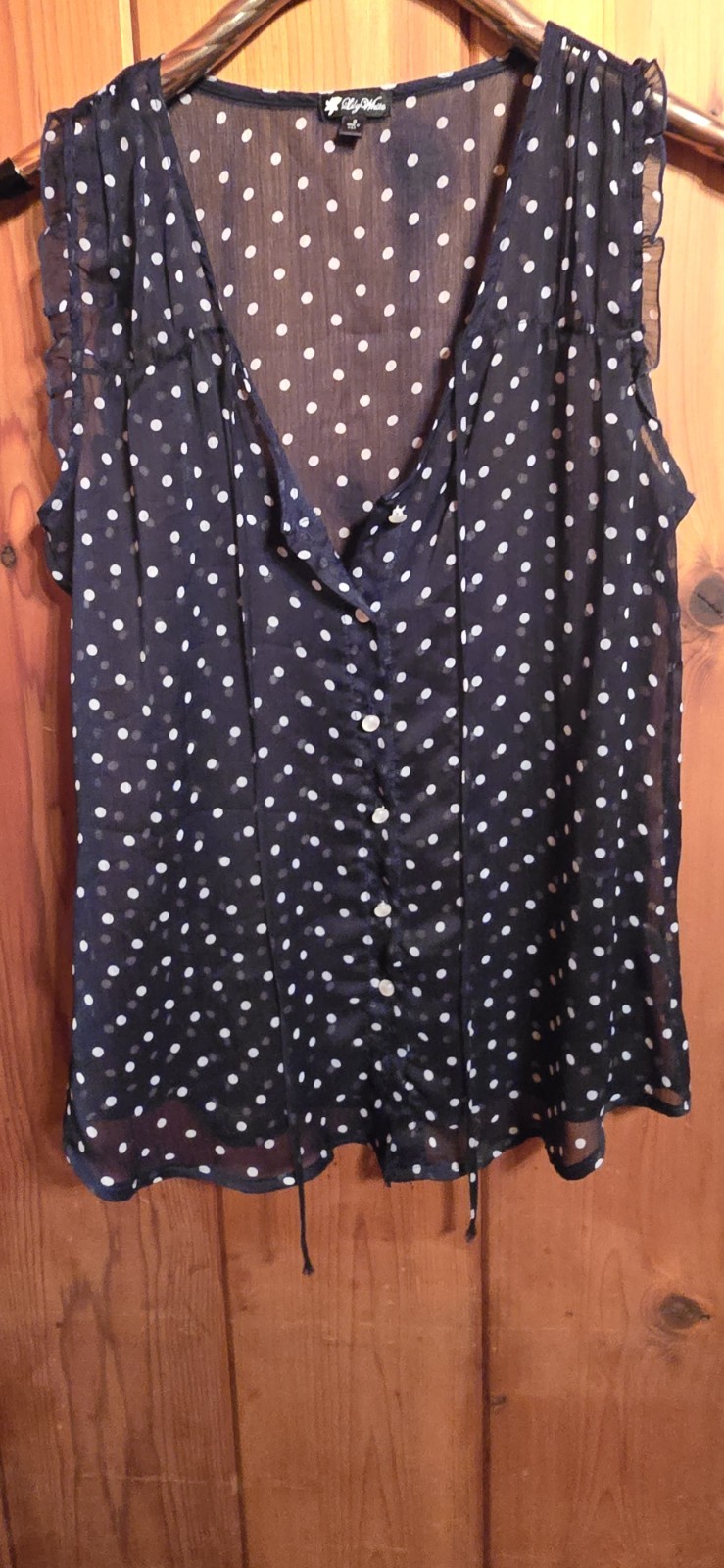 Lily White brand blouse features a sheer navy blue fabric with a white polka dot
